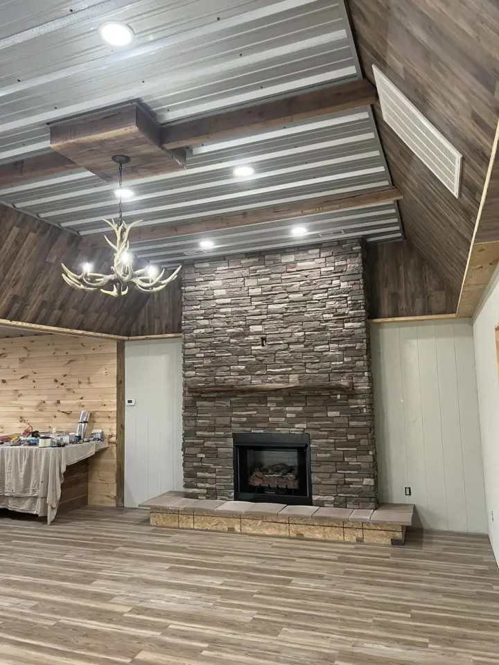 Warm interior of the Kentucky hunting lodge with rustic wood walls and comfortable seating.