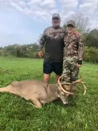 Hunter and guide celebrate a successful Kentucky whitetail hunt.